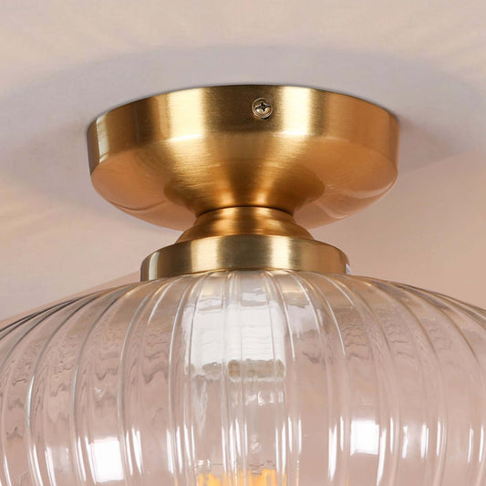 Fluted Glass Flush Ceiling Light with Brushed Brass Finish showcasing the brushed brass base and clear glass shade.