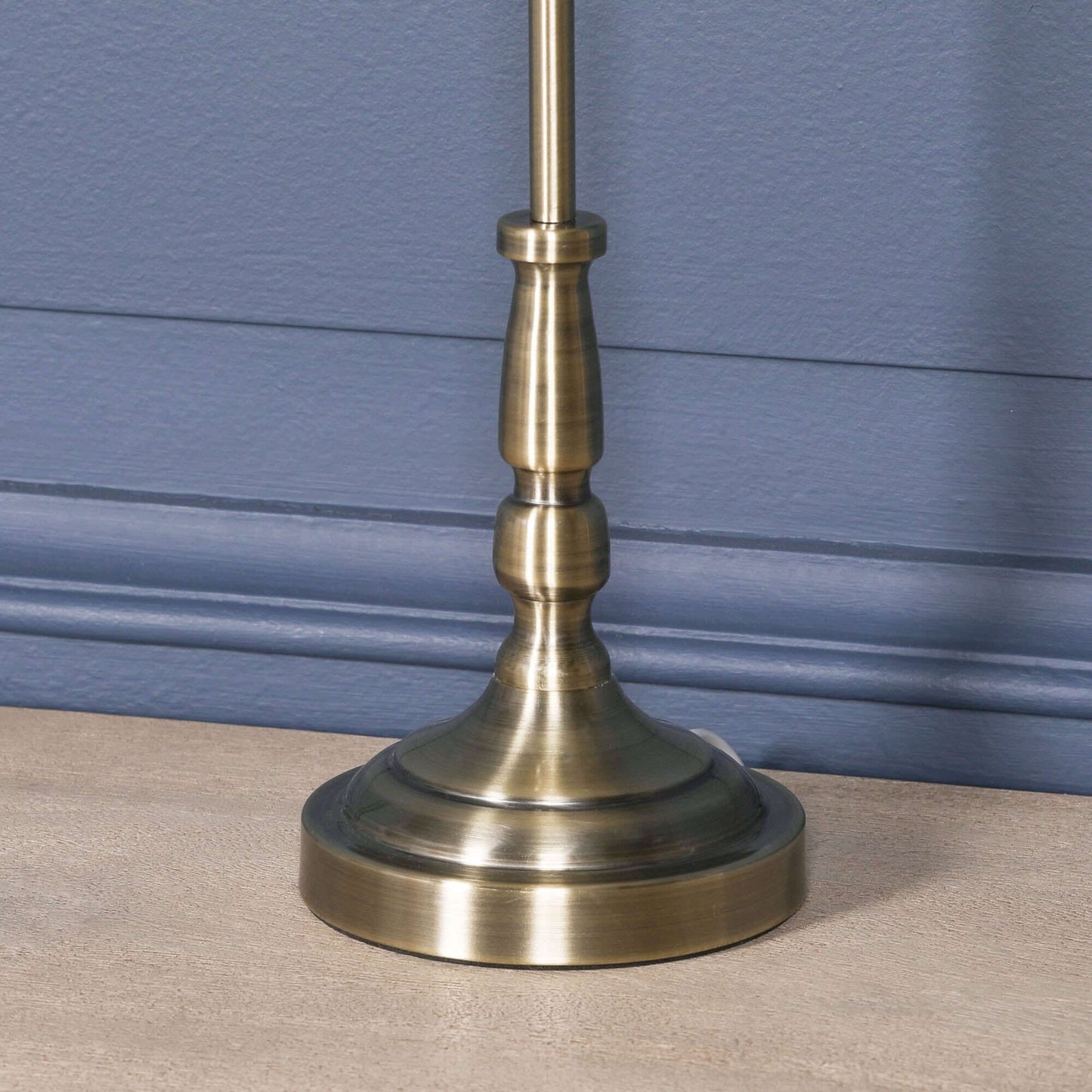 Close-up of the traditional satin brass candlestick table lamp base design, showcasing elegant craftsmanship.