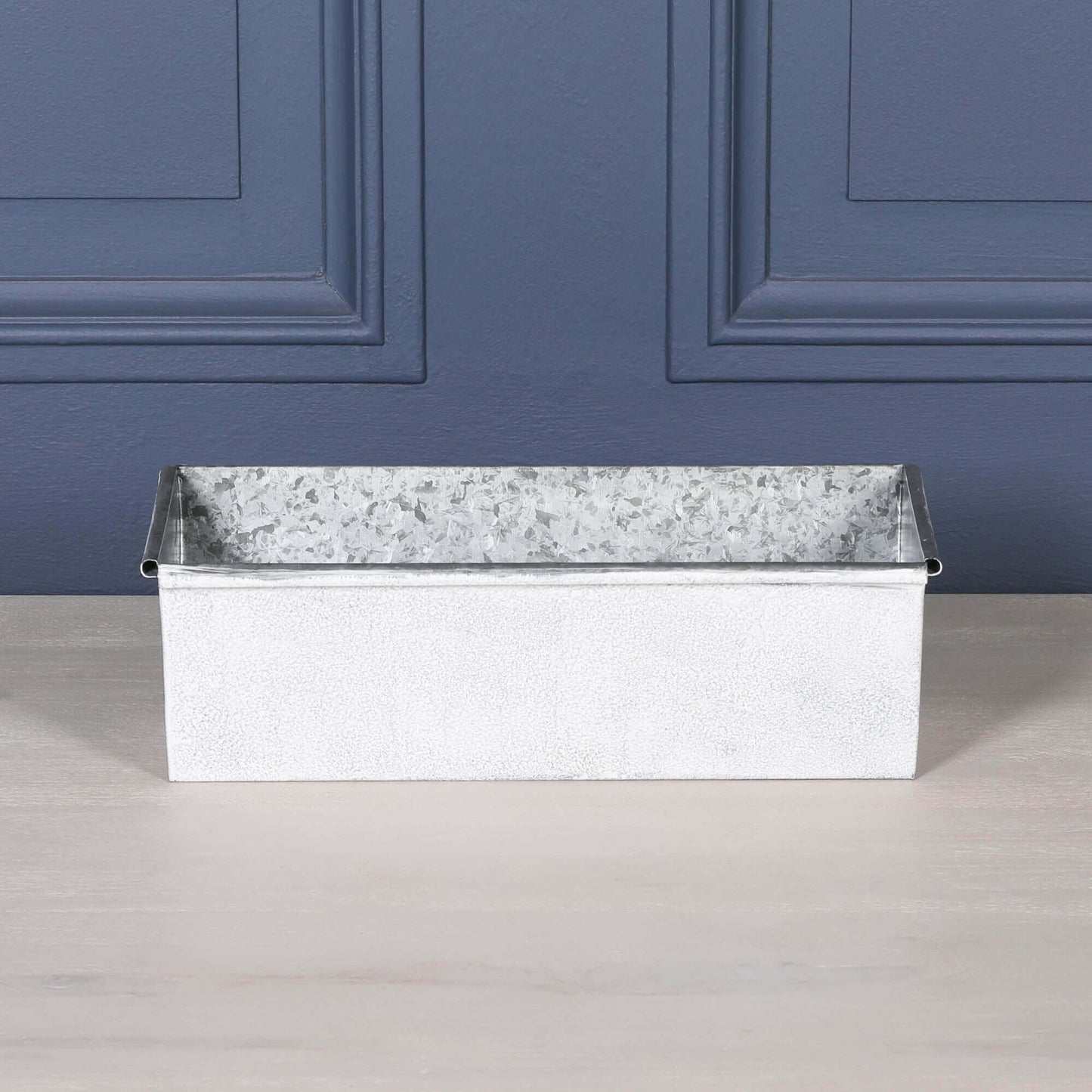 White Wash Metal Window Box Planter Roll Top - 44cm with a rustic design on a wooden surface.