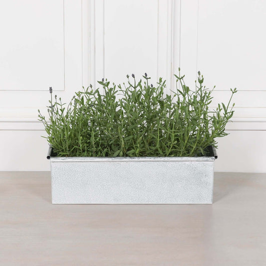 White Wash Metal Window Box Planter filled with greenery on a light surface, adding rustic charm to any space.