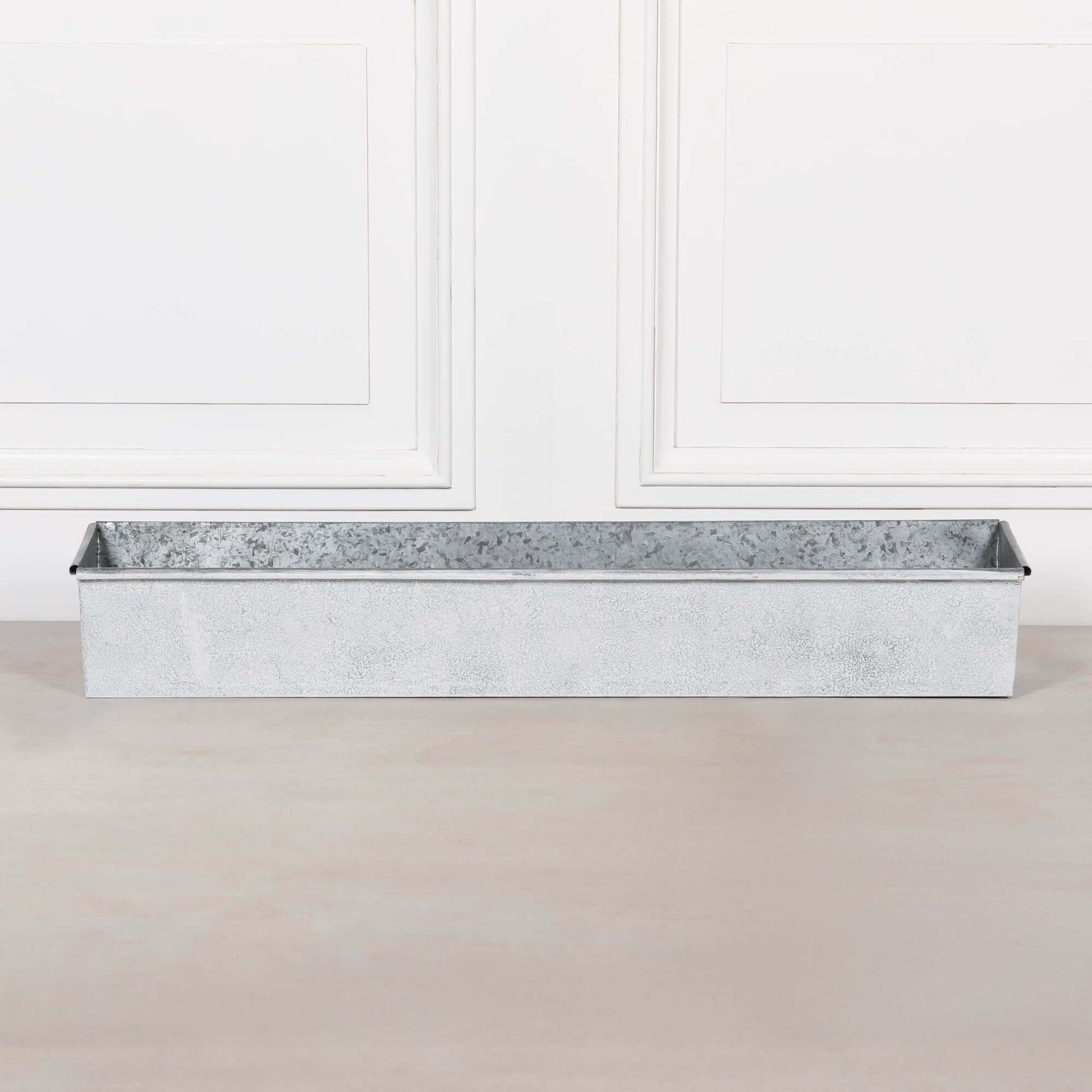 White wash metal window box planter roll top featuring a rustic distressed finish, ideal for plants and flowers.