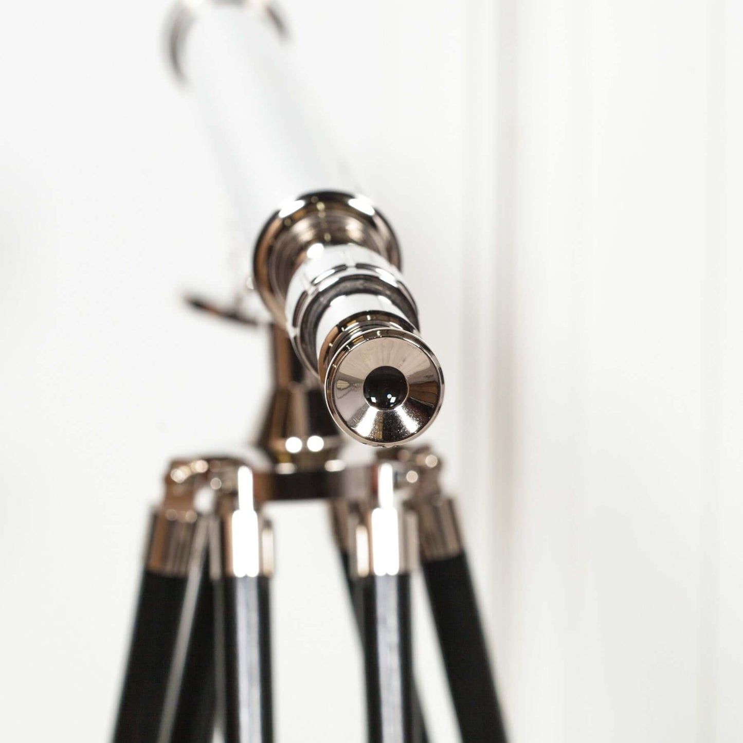 Nickel Tripod Telescope on Black Wooden Stand