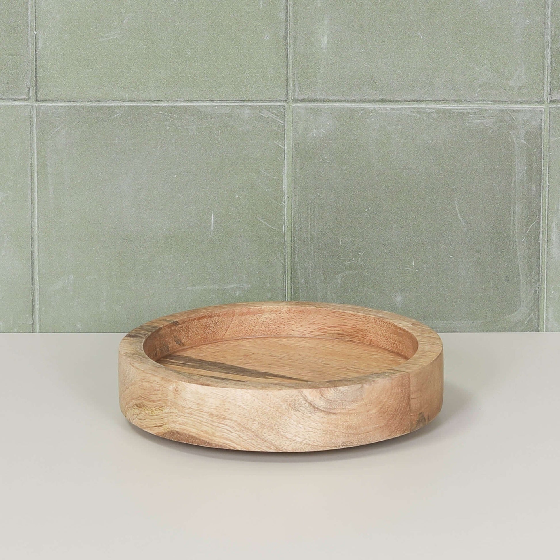 Round 15cm Wooden Tray resting on a light surface with green tiled background.