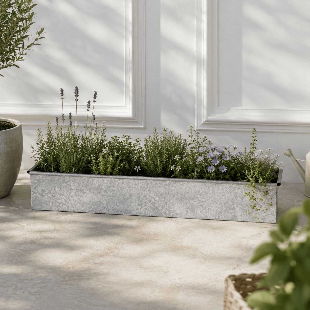 Metal planter with herbs on a wooden deck